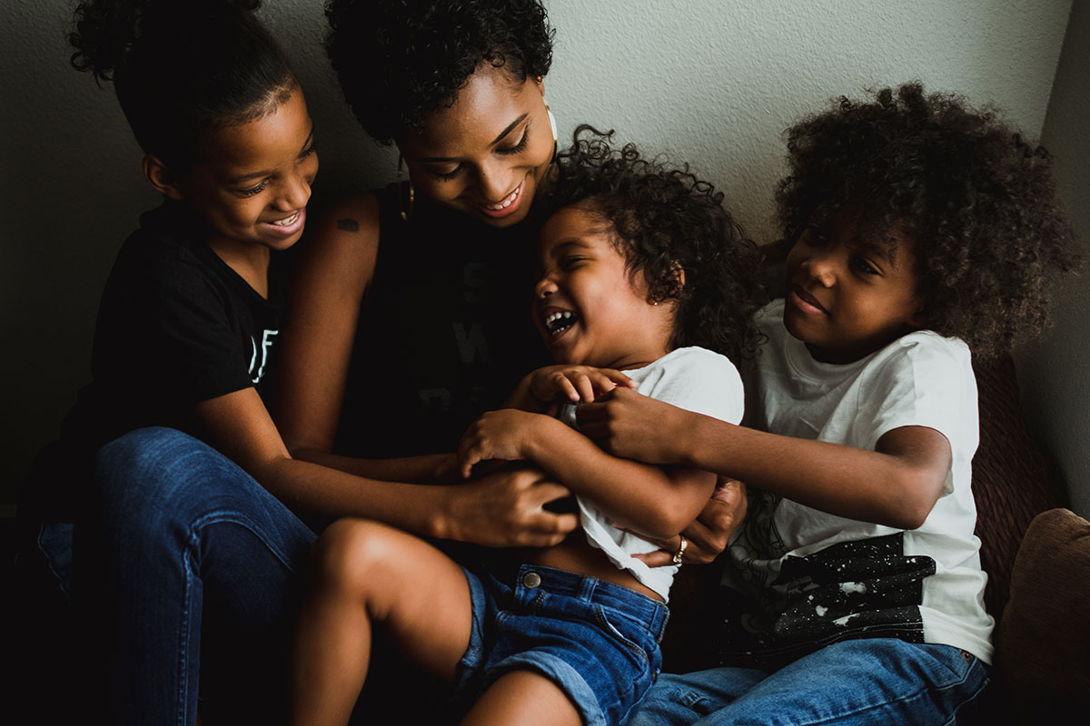 mom snuggling with kids