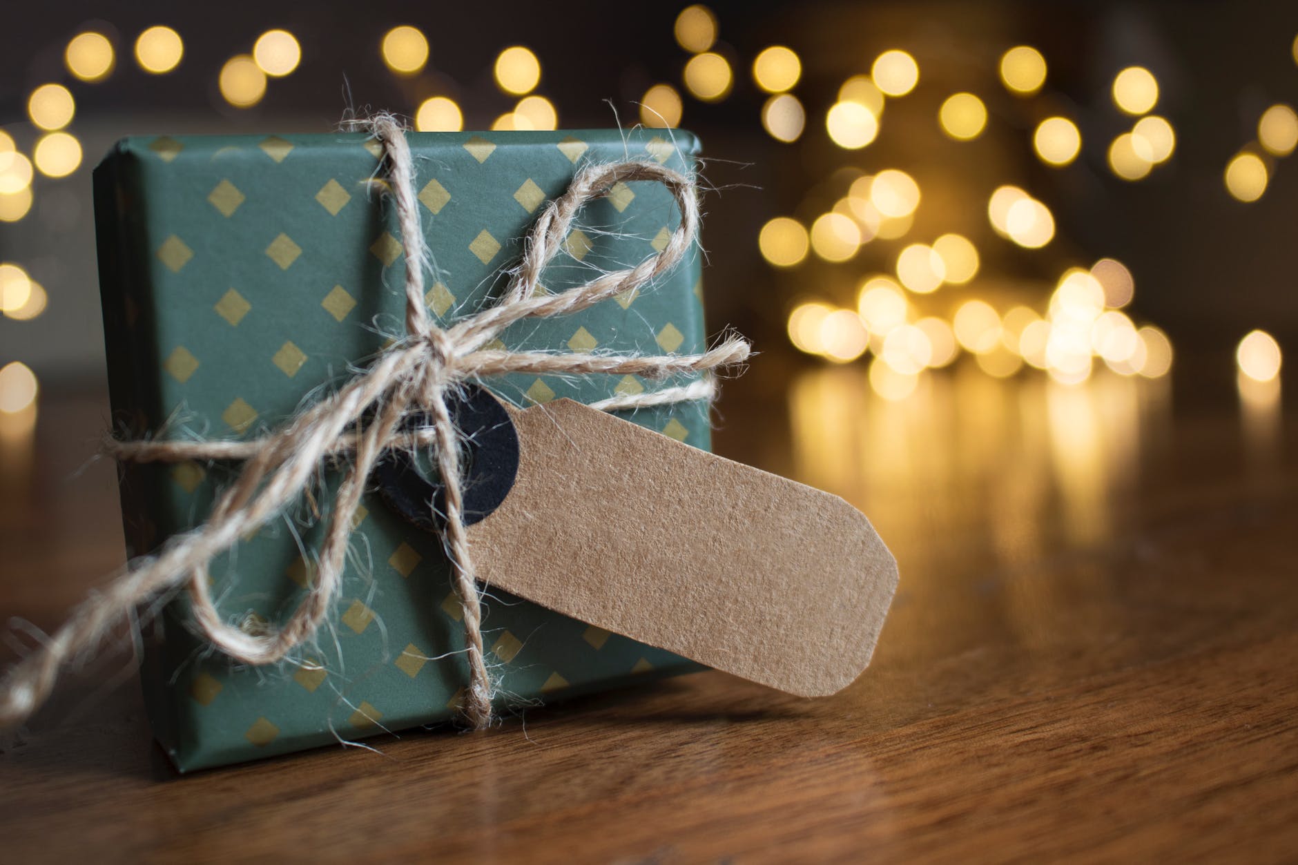 selective focus photography of gift box on brown wooden surface