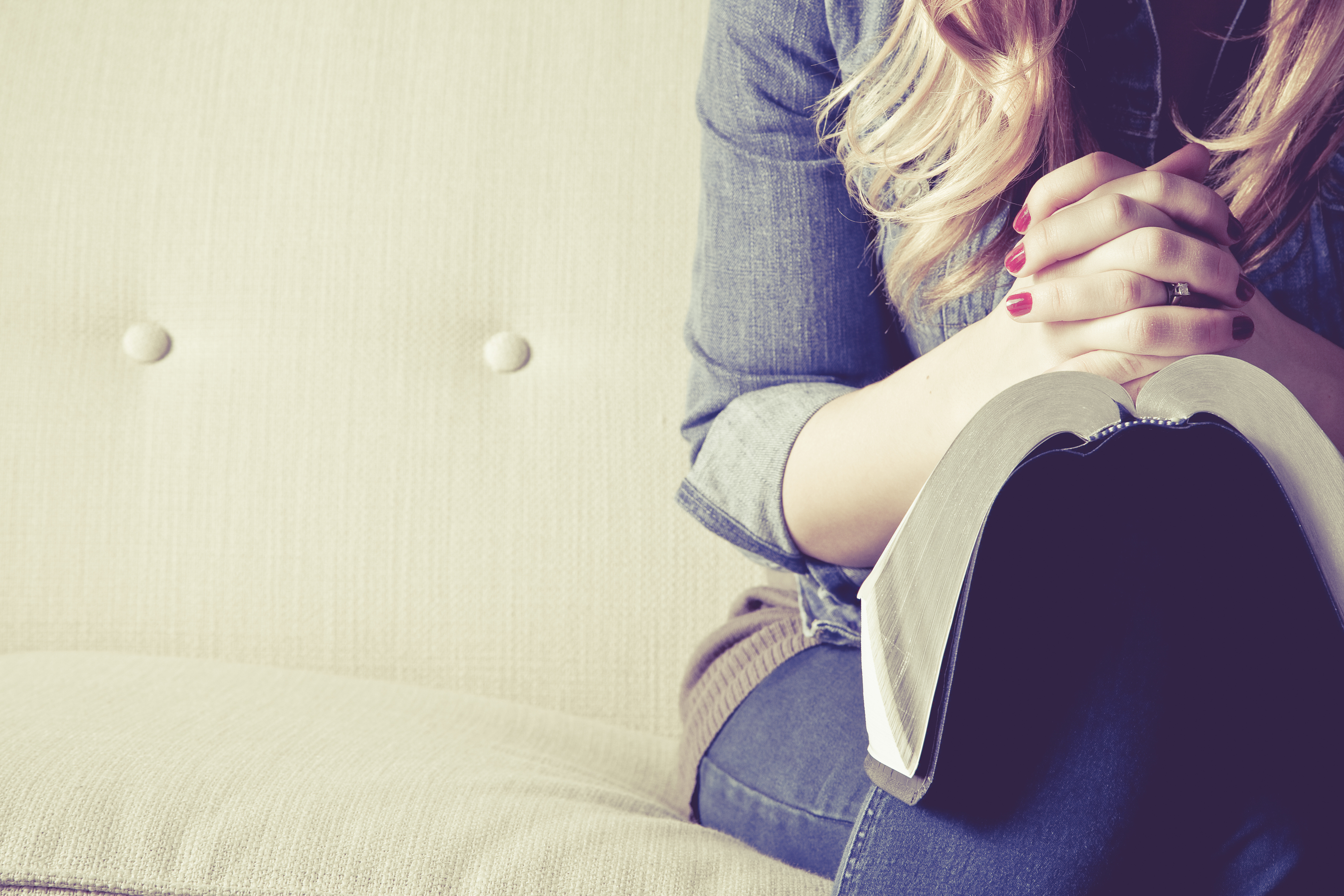 woman praying over bible